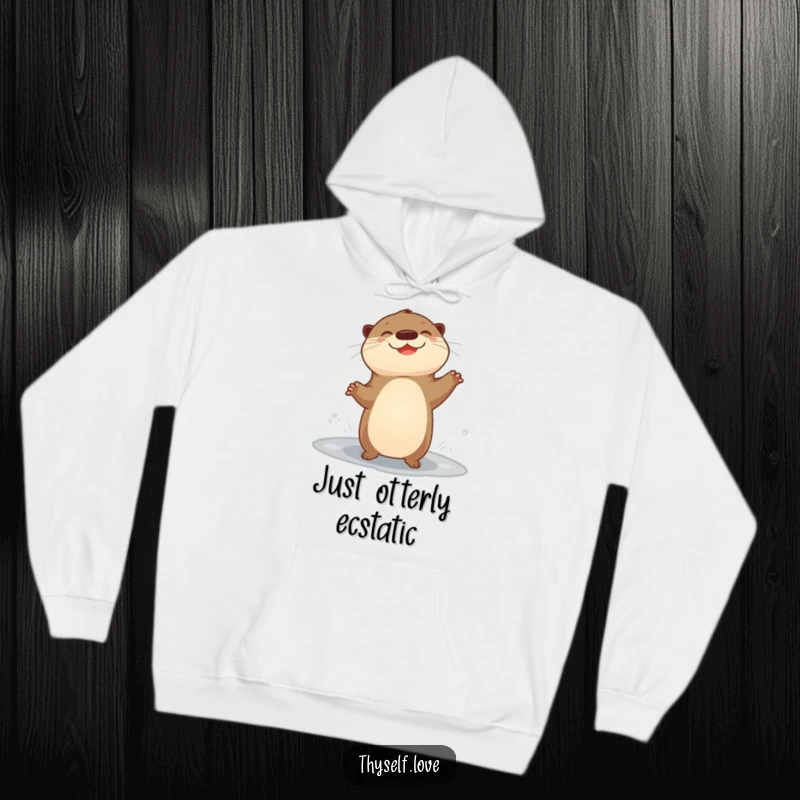 Funny hoodie with a giggling otter performing a happy dance near a puddle, radiating infectious cheerfulness.